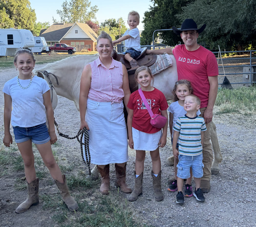 The Rasmussen family with their horse on the farm.